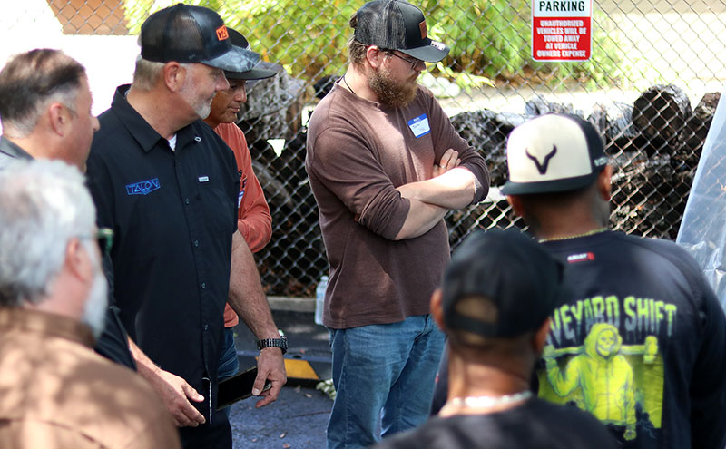 Keith Van Stavern, CEO of TALON Pros, observes a live spray foam insulation demonstration with contractors after presenting on the transition from HFC to HFO blowing agents and its impact on spray foam techniques and business practices.